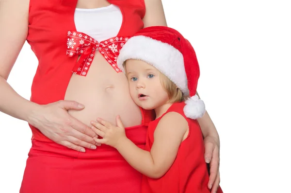 Kind en zwangere vrouw in kerst kleding — Stockfoto