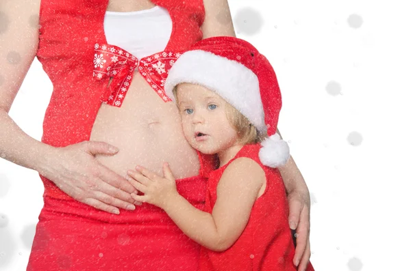 Bambino e donna incinta a Natale, fiocchi di neve — Foto Stock