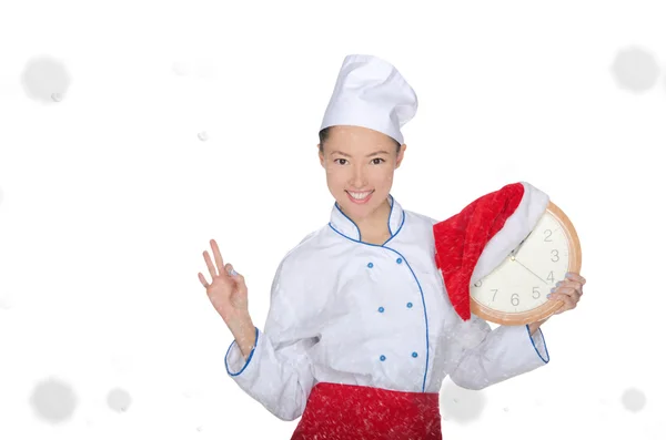 Smiling asian chef with clock and Christmas hat — Stock Photo, Image