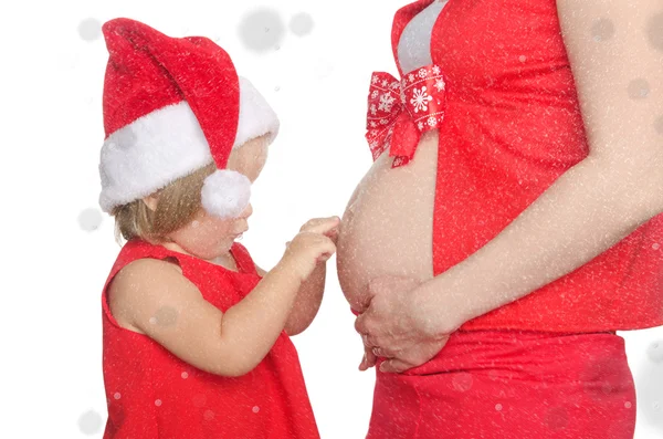 Bambino e donna incinta pancia a Natale, fiocchi di neve — Foto Stock