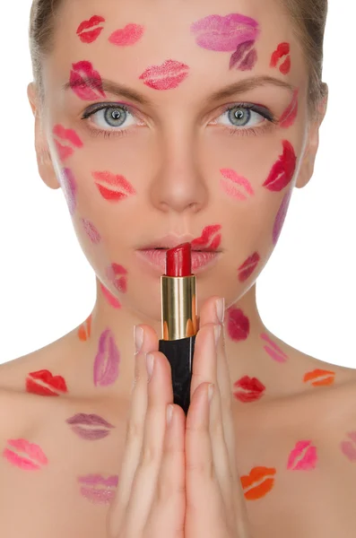 Beautiful woman with kisses on face holding lipstick — Stock Photo, Image