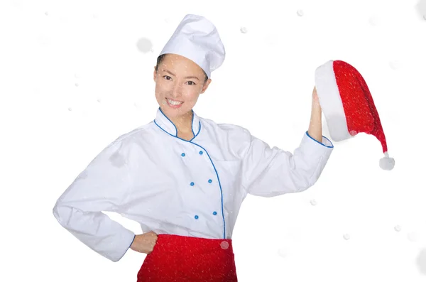 Happy asian chef with christmas cap in snow — Stock Photo, Image