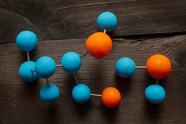 Molecule on wooden background — Stock Photo, Image