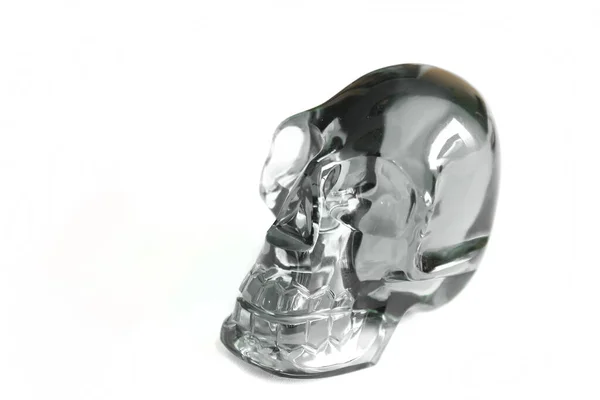 白い背景にクリスタルやガラスで作られた頭蓋骨を通して明確な参照してください — ストック写真