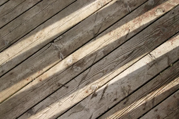 Sun shines through on wooden boards background — Stock Photo, Image