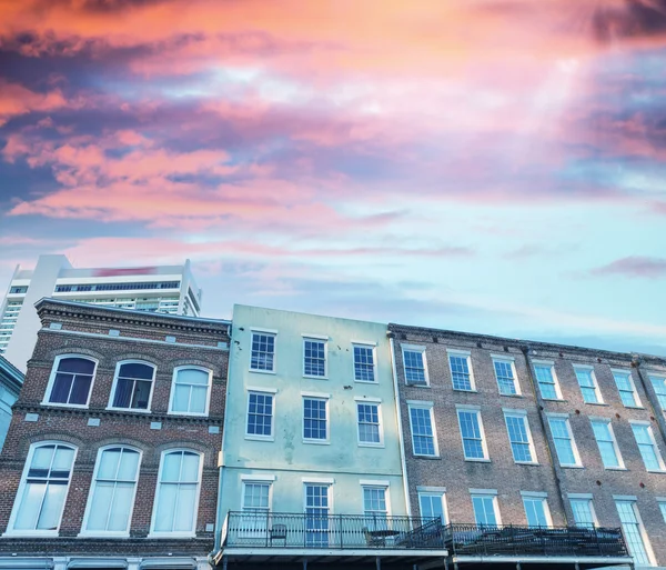 Colourful buildings against sunset sky — Stock Photo, Image