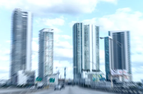 Blurred image of Miami buildings as seen from a moving car