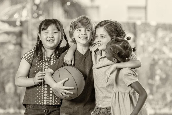 Happy multi ethnic classmates embracing in schoolyard, happiness — Stock Photo, Image