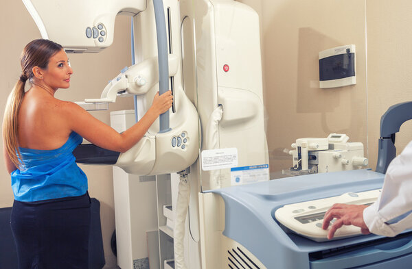 Woman in 40s about to undergoing a mammography test in hospital 