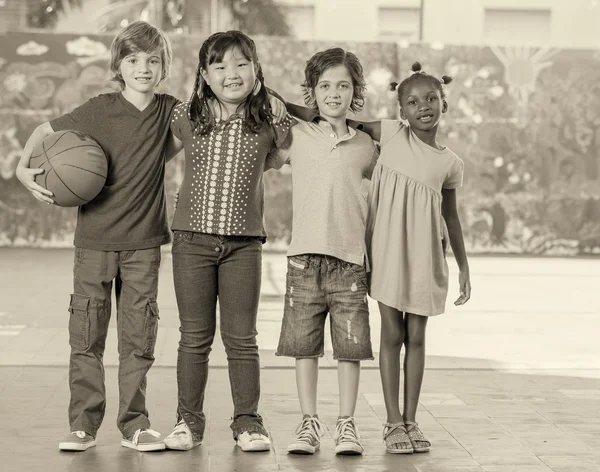 Základní škola děti hrají basketbal v tělocvičně — Stock fotografie