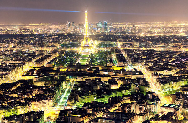 PARIS - NOVEMBER 29, 2012: Illumination of Eiffel Tower at night. Paris attracts 30 million people annually.
