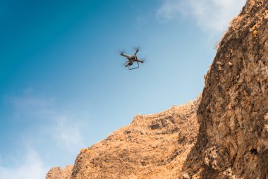 Drone flying through the mountains clipart