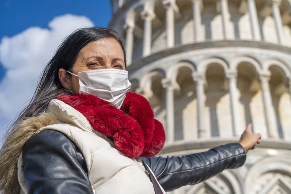 Female tourist wearing health mask visiting italian city.