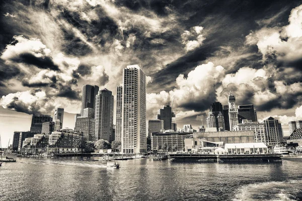 Boston Waterfront skyline. City buildings at sunset seen from Fort Point Channel, Massachusetts, USA