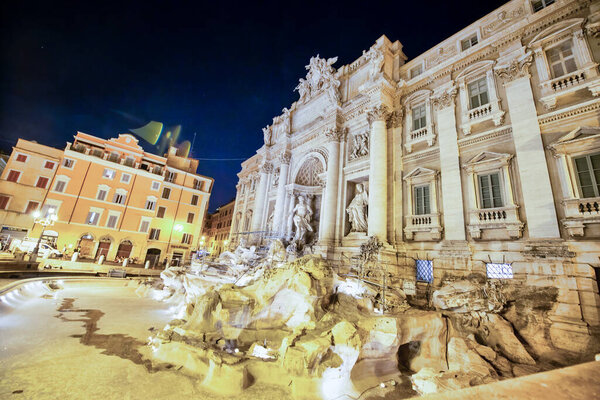 РИМ, ИТАЛИЯ - ИЮНЬ 2014: Туристы наслаждаются прекрасным фонтаном Треви в летнюю ночь.