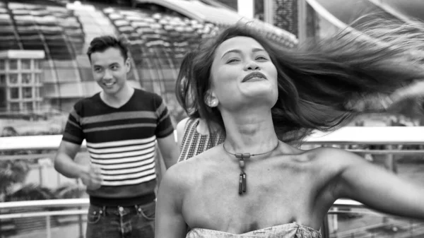 Three asian friends relaxing walking along city streets.