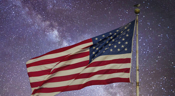 American Flag under a starry night, New York City - USA.