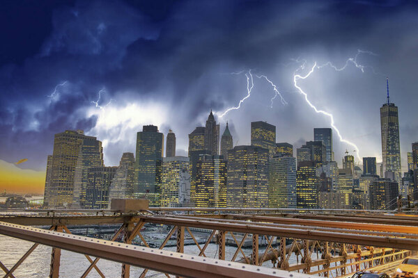 Downtown Manhattan skyline from Brooklyn Bridge under a coming storm, New York City - USA.