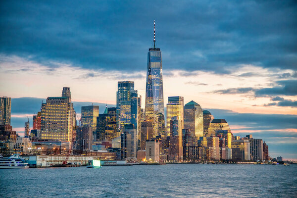 Sunset view of Downtown Manhattan skyline from ferry boat, New York City