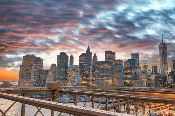 Sunset colors of Downtown Manhattan as seen from Brooklyn Bridge, NYC.