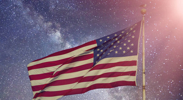 American Flag under a starry night, New York City - USA.