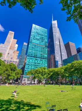 NEW YORK CITY - JUNE 11, 2013: Tourists enjoy Bryant Park on a sunny day.