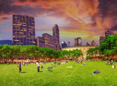 NEW YORK CITY - JUNE 11, 2013: Tourists enjoy night life in Bryant Park.