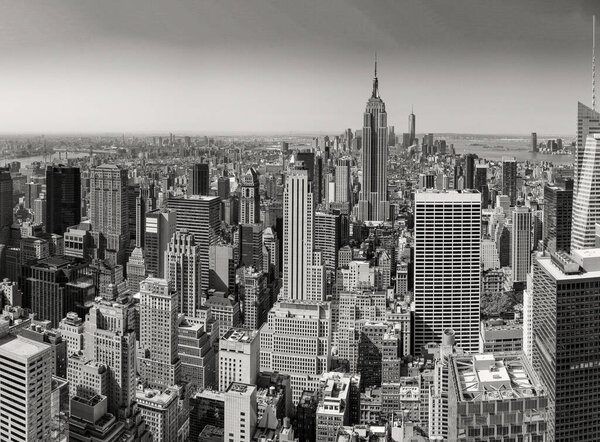 Black and white panoramic aerial view of New York City skyline. Manhattan skyscrapers from rooftop.