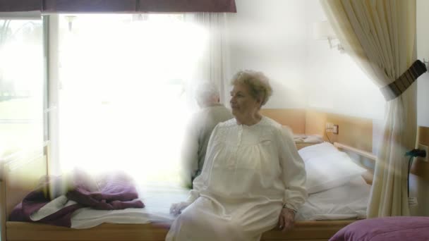 Elderly couple going to bed in hospital, light rays coming from outside — Stock Video