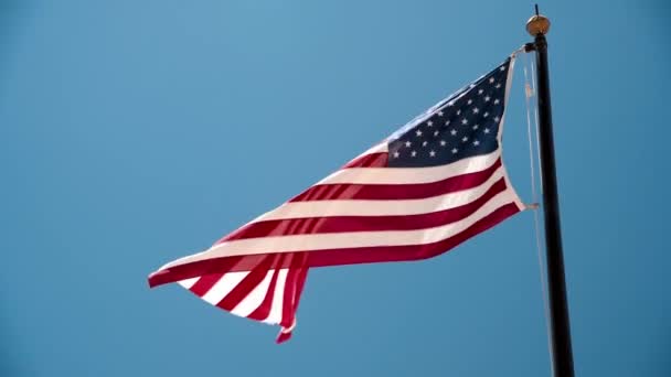 Beautiful american flag against the blue sky Slow motion — Stock Video