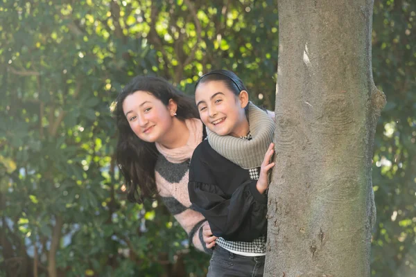 Happy Young Girls Outdoor Hiding Tree — Stock Photo, Image