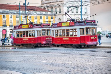 LISBON, PORTUGAL - OCTOBER 30, 2018: Red tram along the ancient city streets