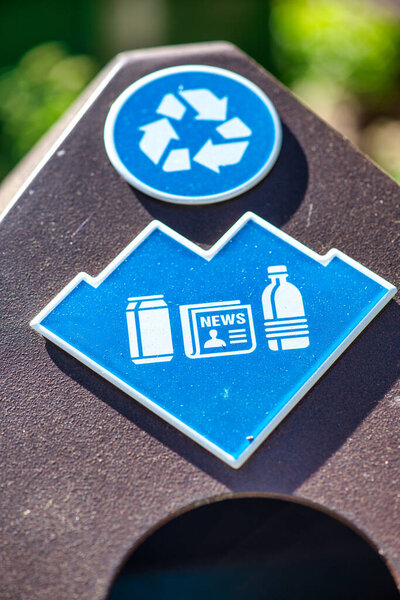 Plastic recycle signs on a trashcan
