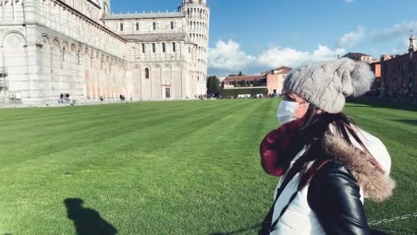 Woman walking outdoor with face mask in front of a landmark. Pandemic concept — Stock Video