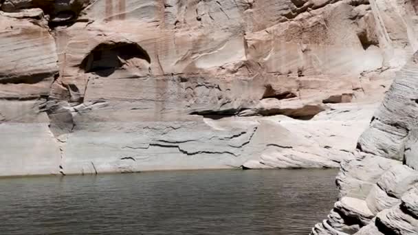 Vörös homokkőből származó dombok veszik körül a tavat. A Powell-tó kanyonja a Colorado folyón — Stock videók