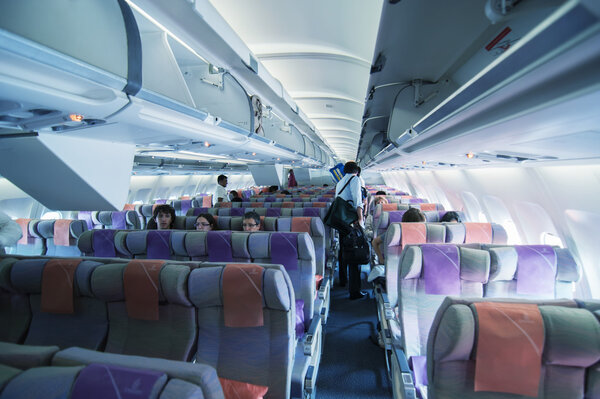 Tourists take a seat on a Emirates flight.