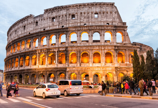 Tourists enjoy Colosseum at night.