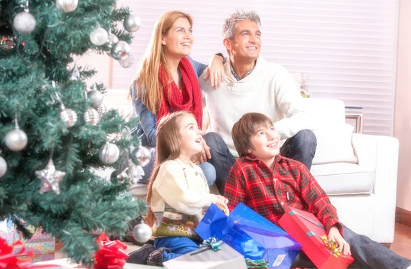 Family near Chrismas tree — Stock Photo, Image