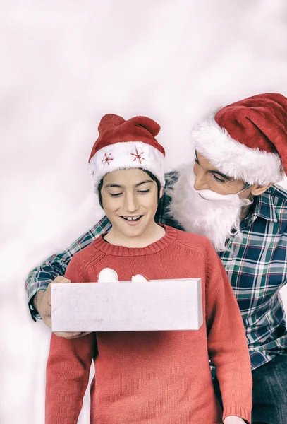 Surprised son receiving Christmas gift — Stock Photo, Image