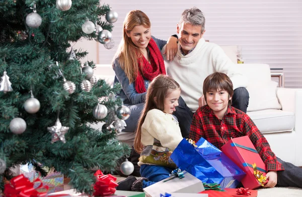 Happy family under Christmas tree.