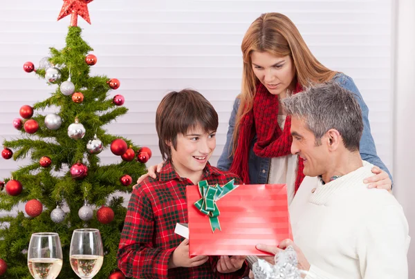 Child receiving Christmas gift — Stock Photo, Image