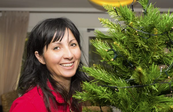 Woman decorating Christmas tree — Stock Photo, Image