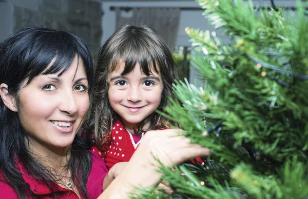 Baby girl with mother enjoying Christmas tree — Stock Photo, Image