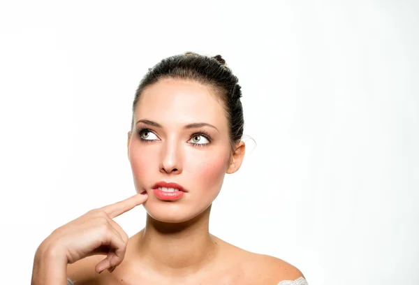 Young businesswoman with finger on chin — Stock Photo, Image