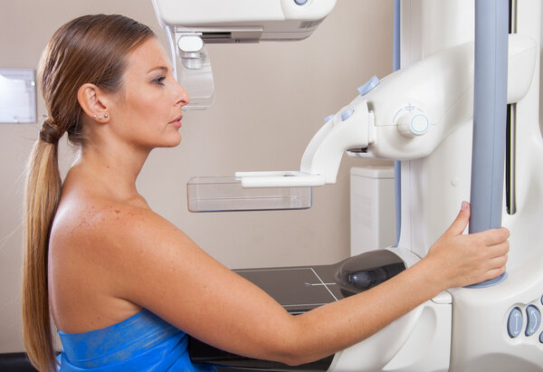 Woman undergoing mammography scan
