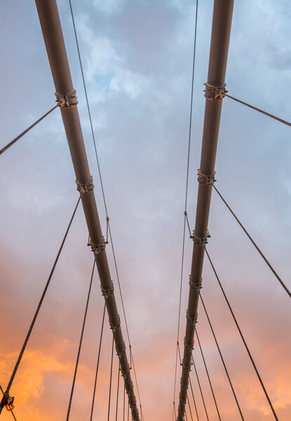 Wires and structure of suspension bridge at dusk.