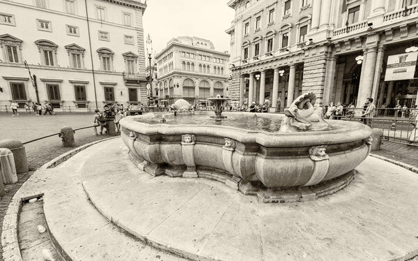 Tourists walk in Piazza Colonna