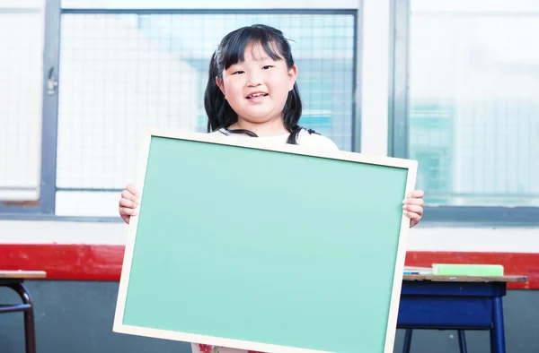 Asian female girl holding empty chalkboard — Stock Photo, Image