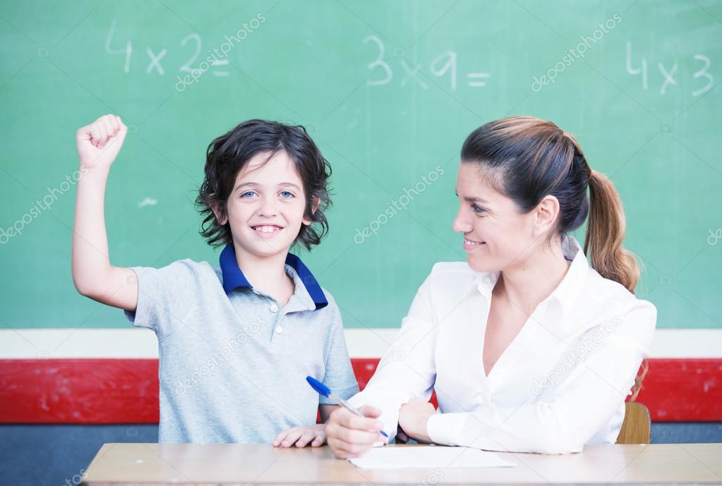 Happy elementary student smiling after answering correctly to th