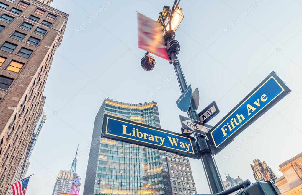 Library way and Fifth avenue street signs in New York City